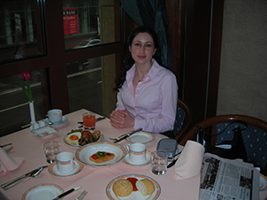 Kris Safarova seated at breakfast before a client engagement in Moscow