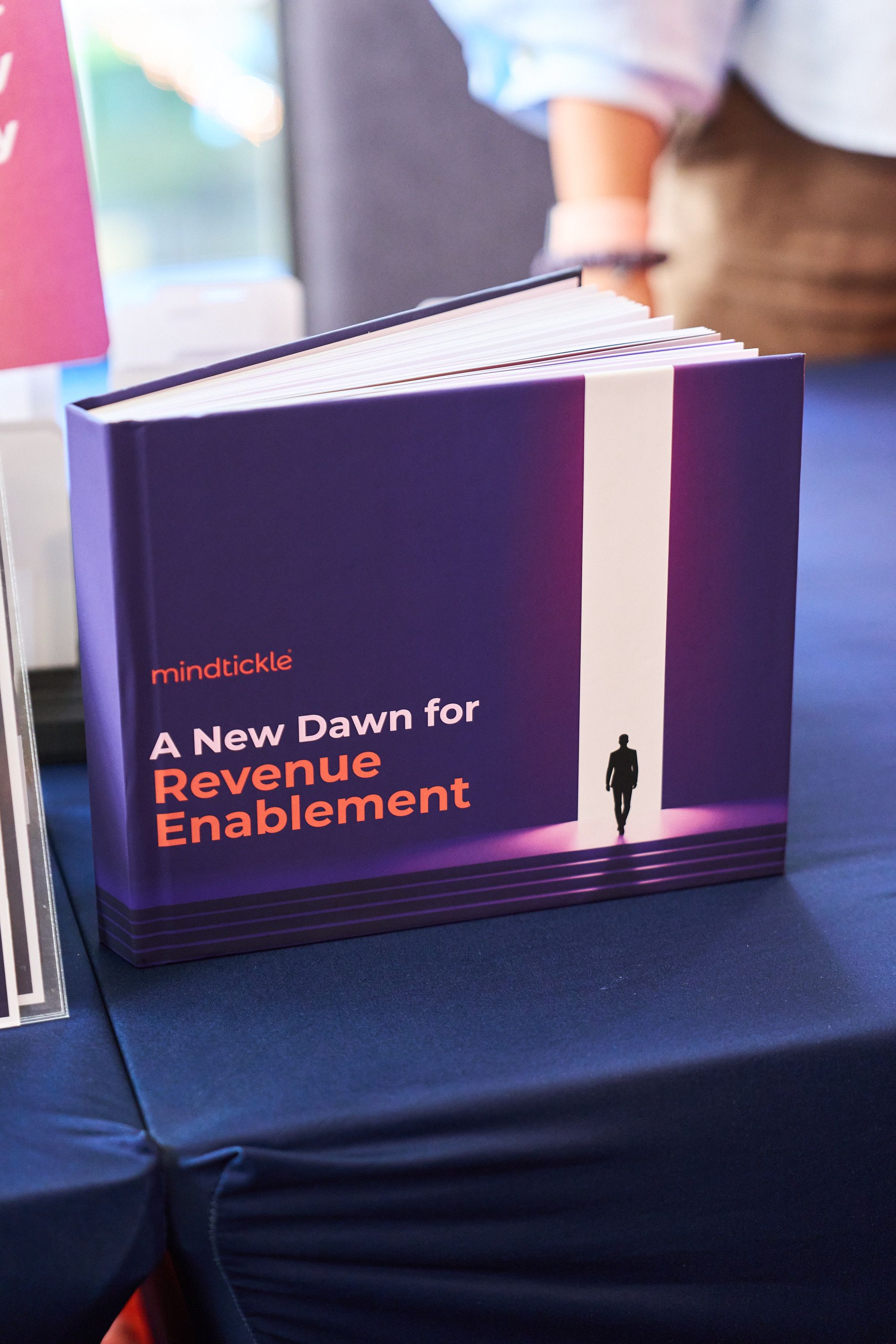 Mindtickle’s A New Dawn for Revenue Enablement book displayed at its customer summit