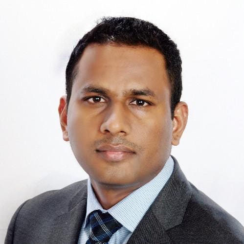 Krishna Dunthoori in a gray jacket and blue tie