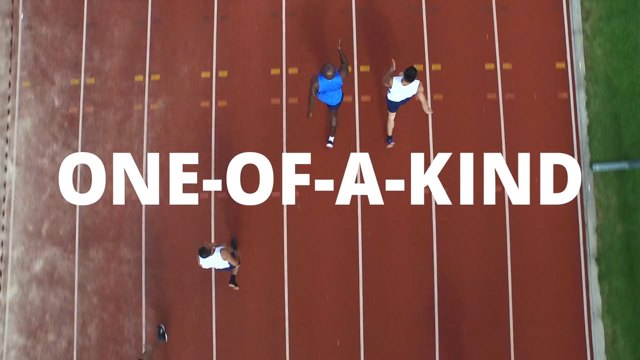 Overhead frame from Clarity Benefit Solutions' Simply Smarter brand film, showing runners on a track with the words One-of-a-kind