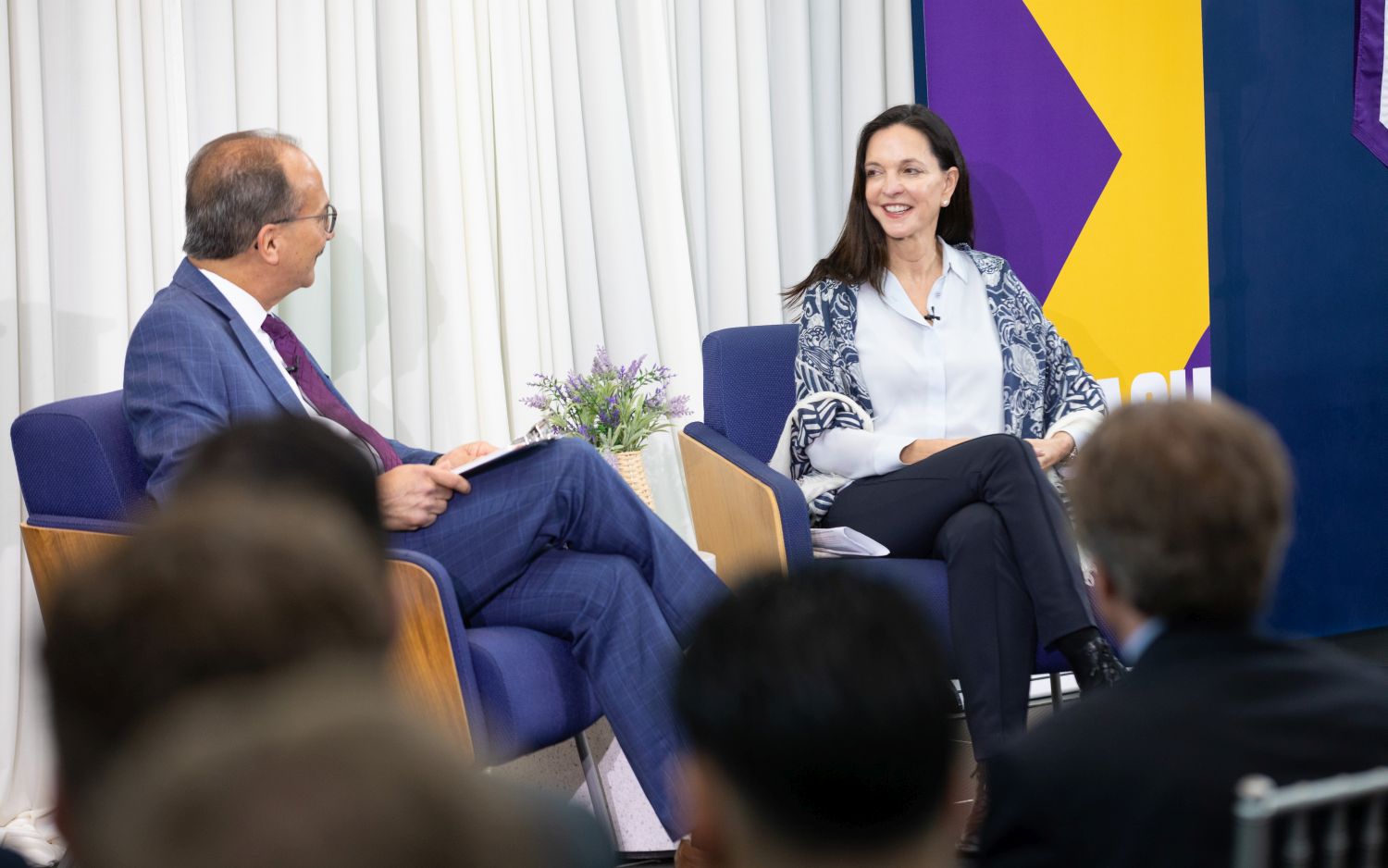 Kristin Dolan, right, speaks with UAlbany President Havidán Rodríguez before an audience.