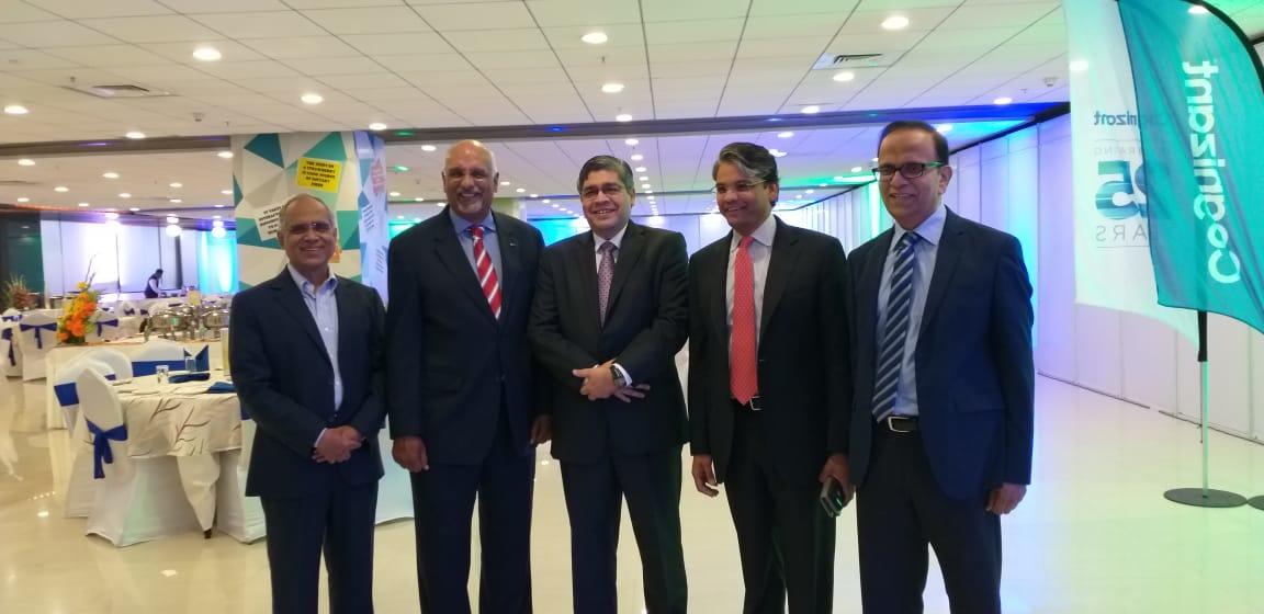 Five Cognizant leaders at the company’s 25th-anniversary gathering, with Kumar Mahadeva standing at far right.