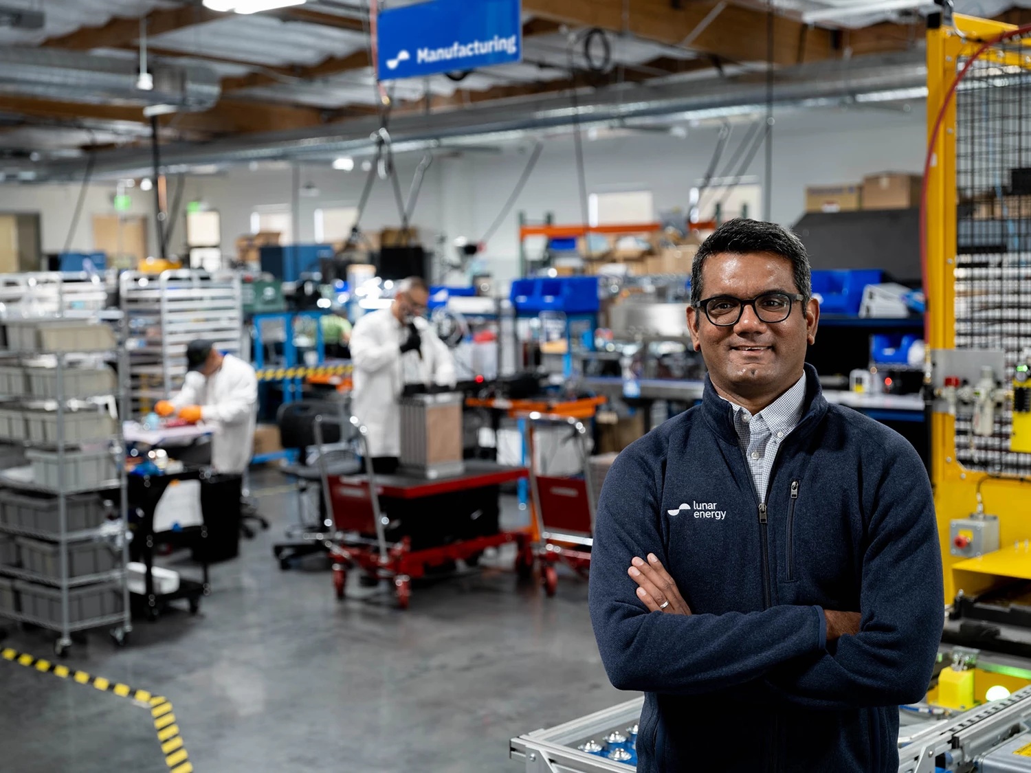 Kunal Girotra standing in Lunar Energy’s Mountain View laboratory, with engineers and equipment behind him