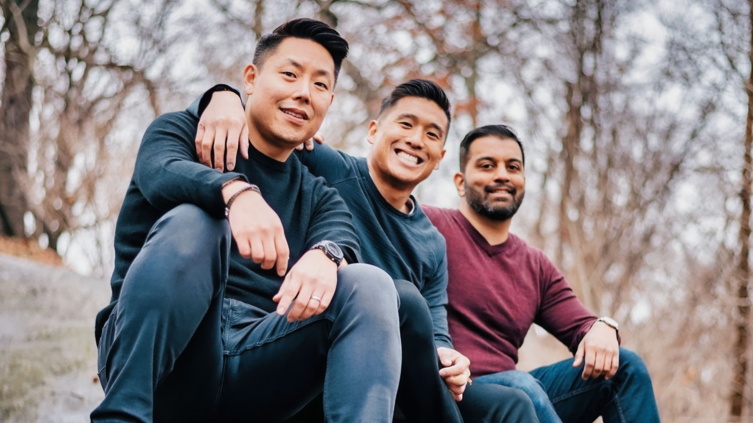 Pinwheel co-founders Curtis Lee, Kurt Lin and Anish Basu sitting together outdoors
