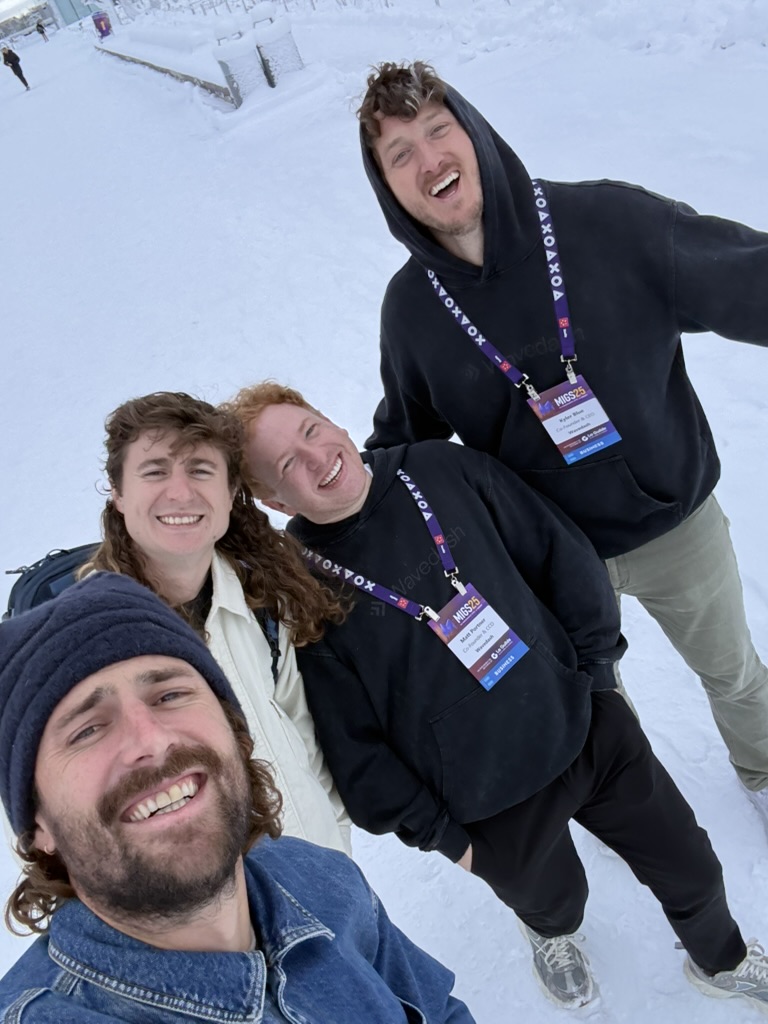 Kyler Blue and fellow Wavedash team members smiling in a snowy outdoor group selfie