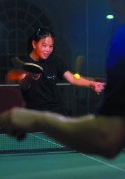Kyna Fong playing table tennis at Harvard, preparing a backhand shot