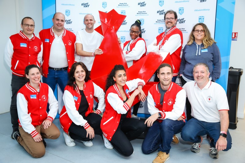 French Tech Paris-Saclay community members gathered around a large red rooster sculpture