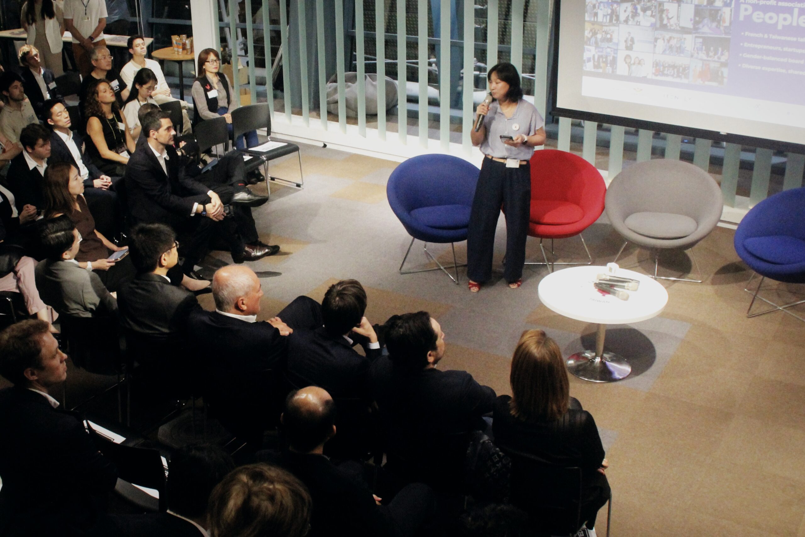 Attendees gathered around a speaker and colorful chairs at French Tech Night 2026