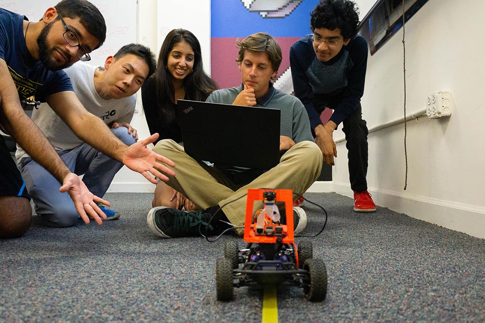 Donkey Darlings project team gathered with a small autonomous research vehicle