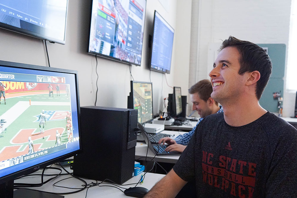 Laber Labs researchers working with the Madden football simulation setup