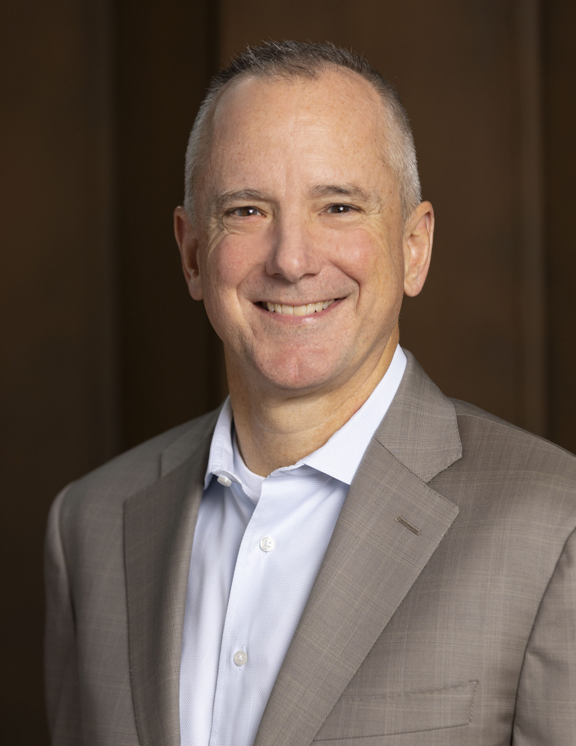 J. A. Lacy in a light jacket, in a separate official LDI portrait