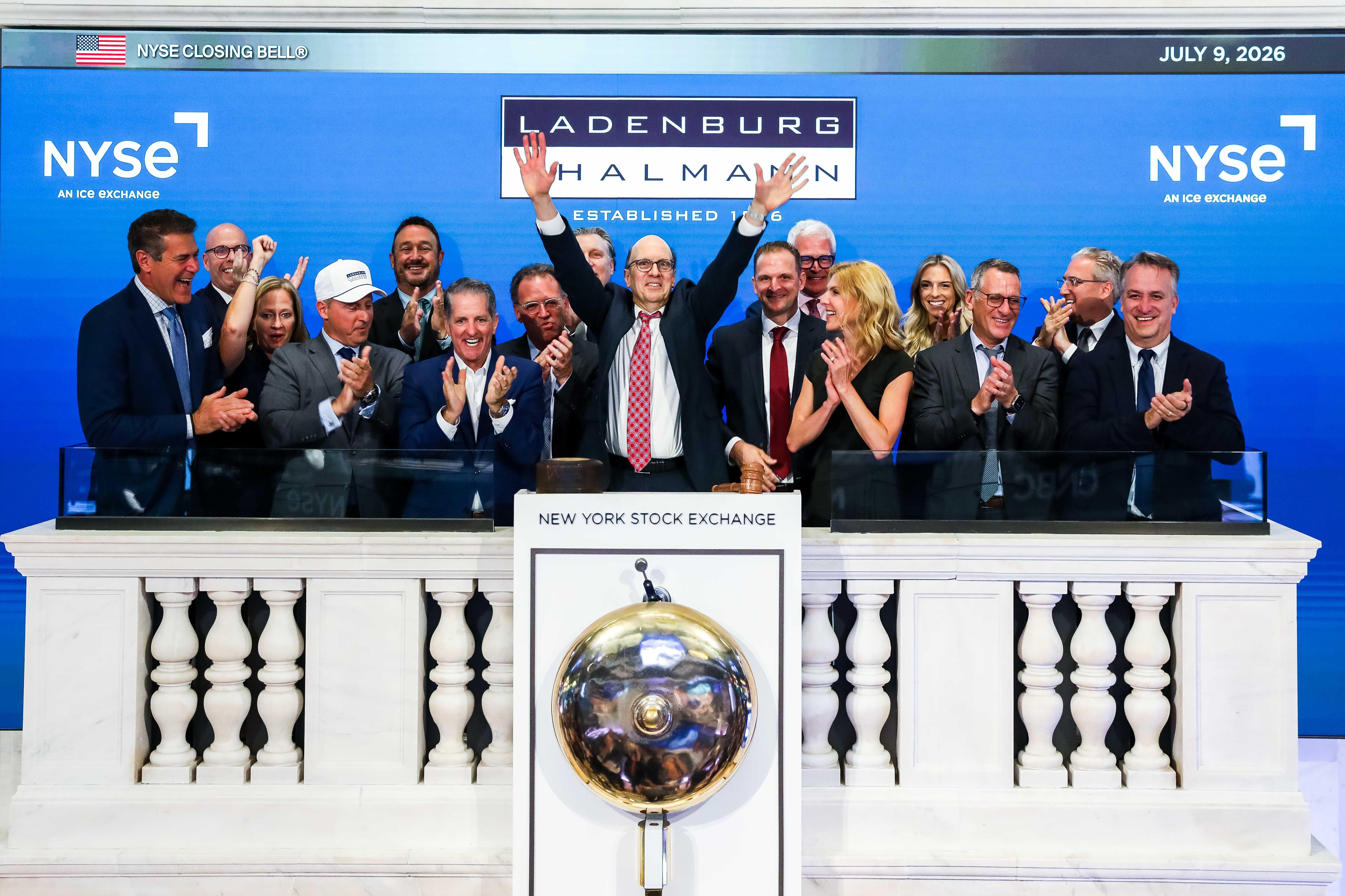 Ladenburg representatives applaud at the NYSE closing bell on July 9, 2026