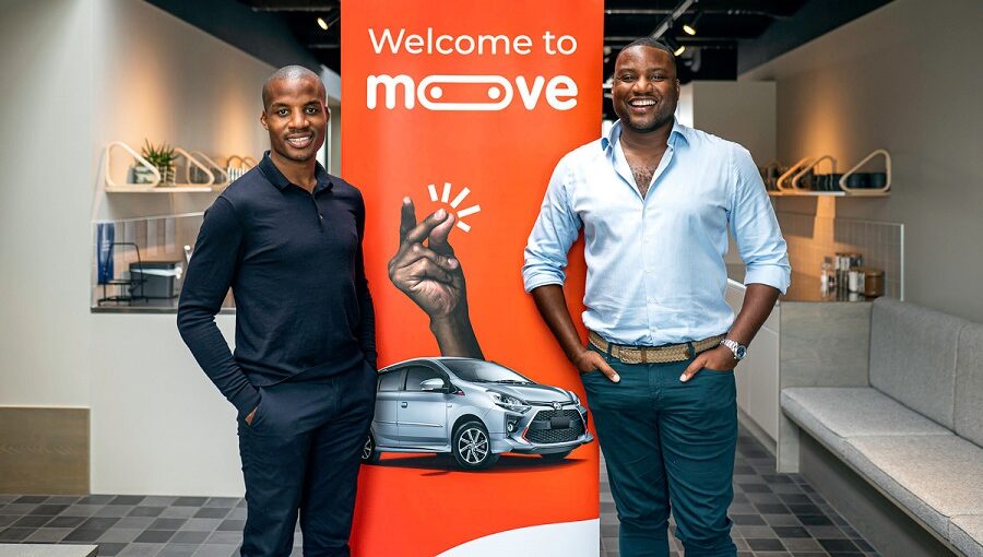 Moove co-founders Jide Odunsi, left, and Ladi Delano, right, standing beside a Moove display