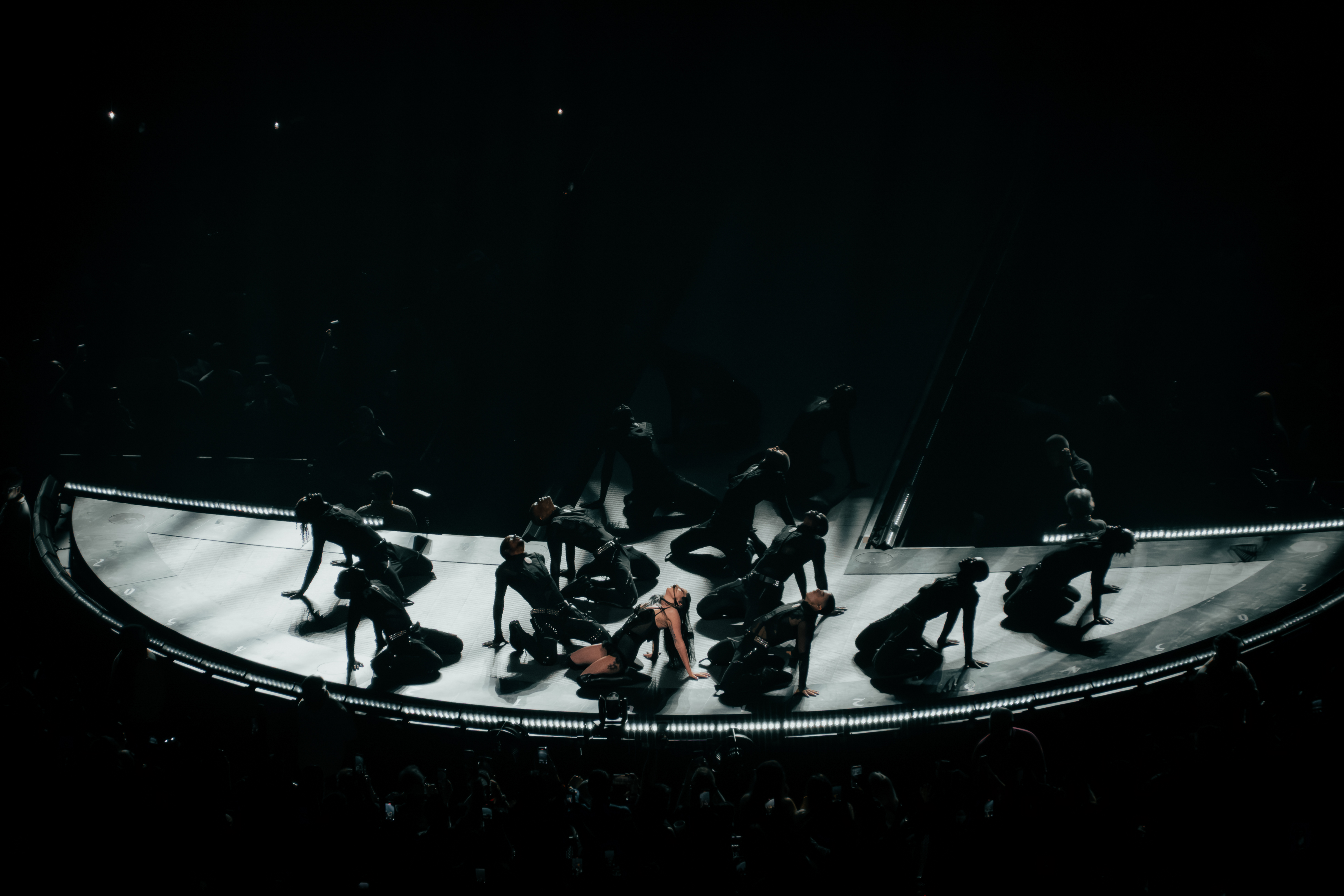 Lady Gaga and dancers perform on a curved stage during the Mayhem Ball in London