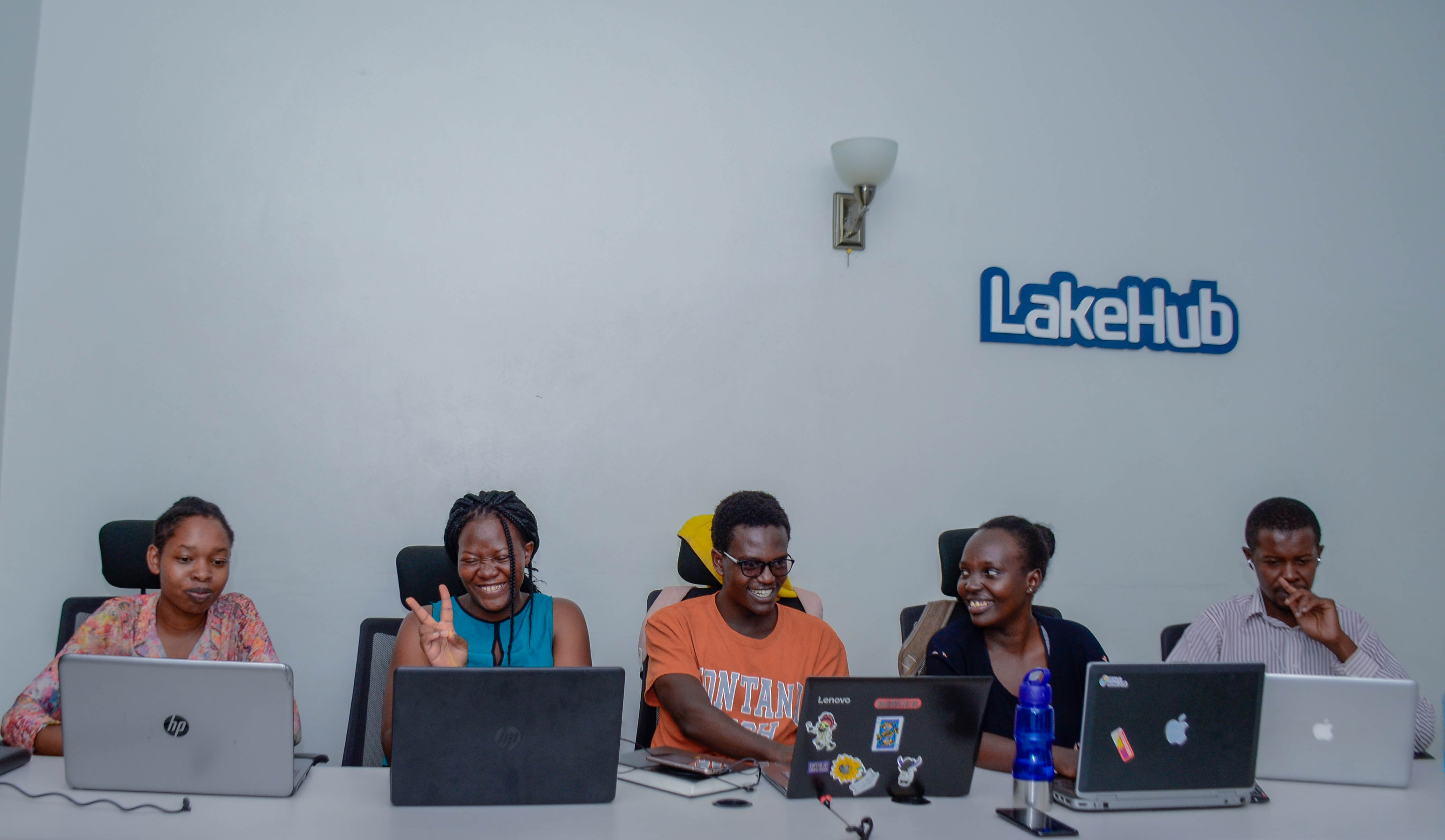 Five people with laptops sharing a table at LakeHub