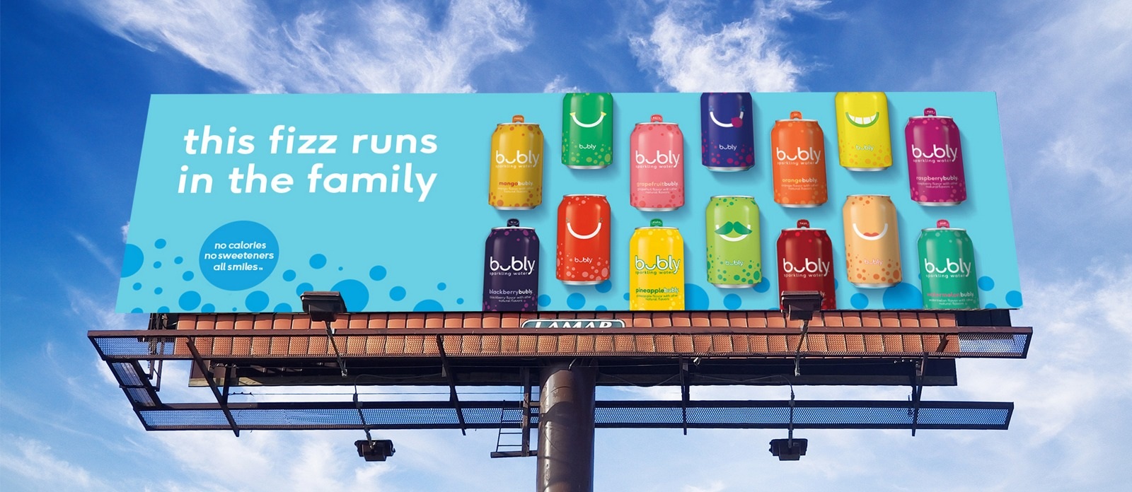 A Lamar roadside billboard showing colorful Bubly cans against a blue sky