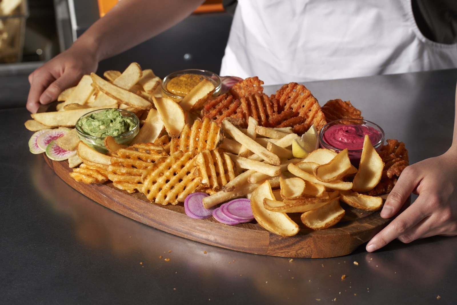 A board of Lamb Weston straight fries, waffle fries, and potato puffs