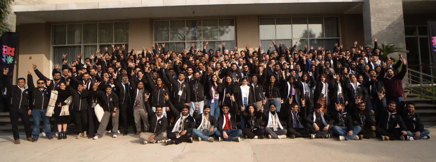 A large group from the TestMu AI team gathered outside an office