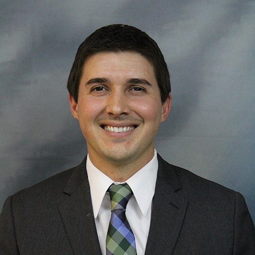 Archival press photograph of Landon Grace in a suit and patterned tie