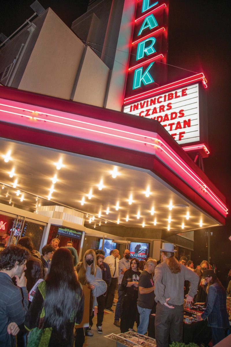 Audience gathering beneath the Lark Theater’s illuminated marquee at night