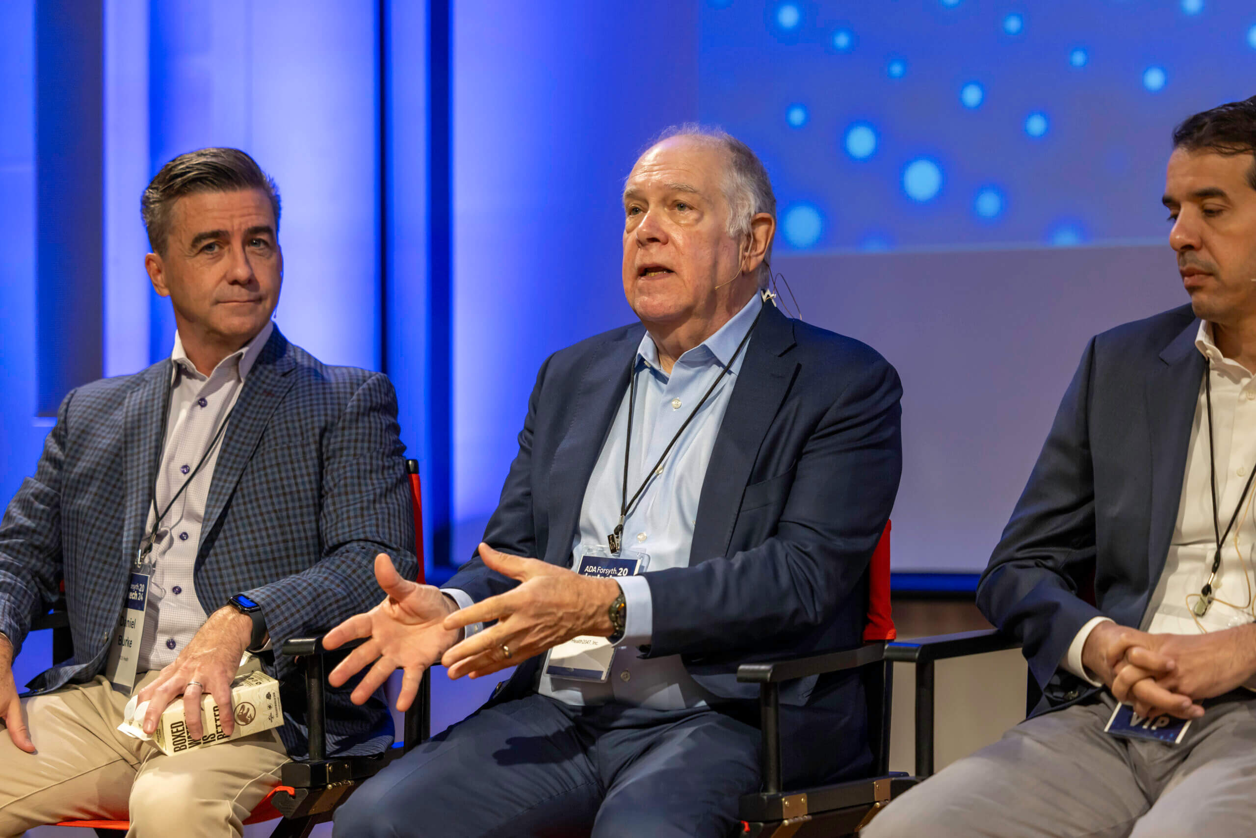 Larry Cohen, seated between fellow panelists, speaking at dentech 2024