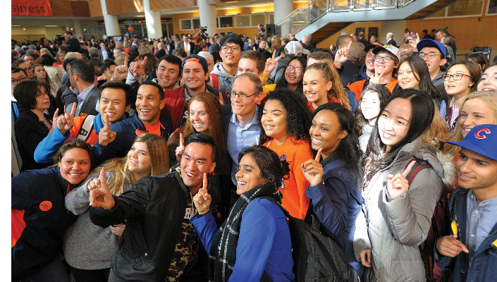 Larry Gies surrounded by smiling students at the University of Illinois