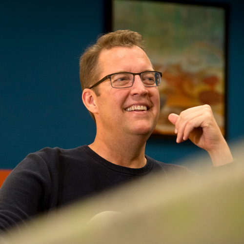 Gary Larson, founder of Larson Communications, seated and smiling
