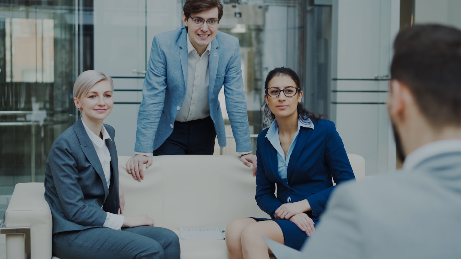 Four colleagues in conversation during an office meeting