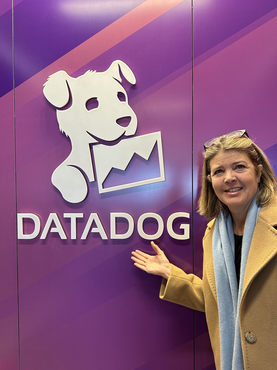 Laura Norman standing beside a large Datadog sign