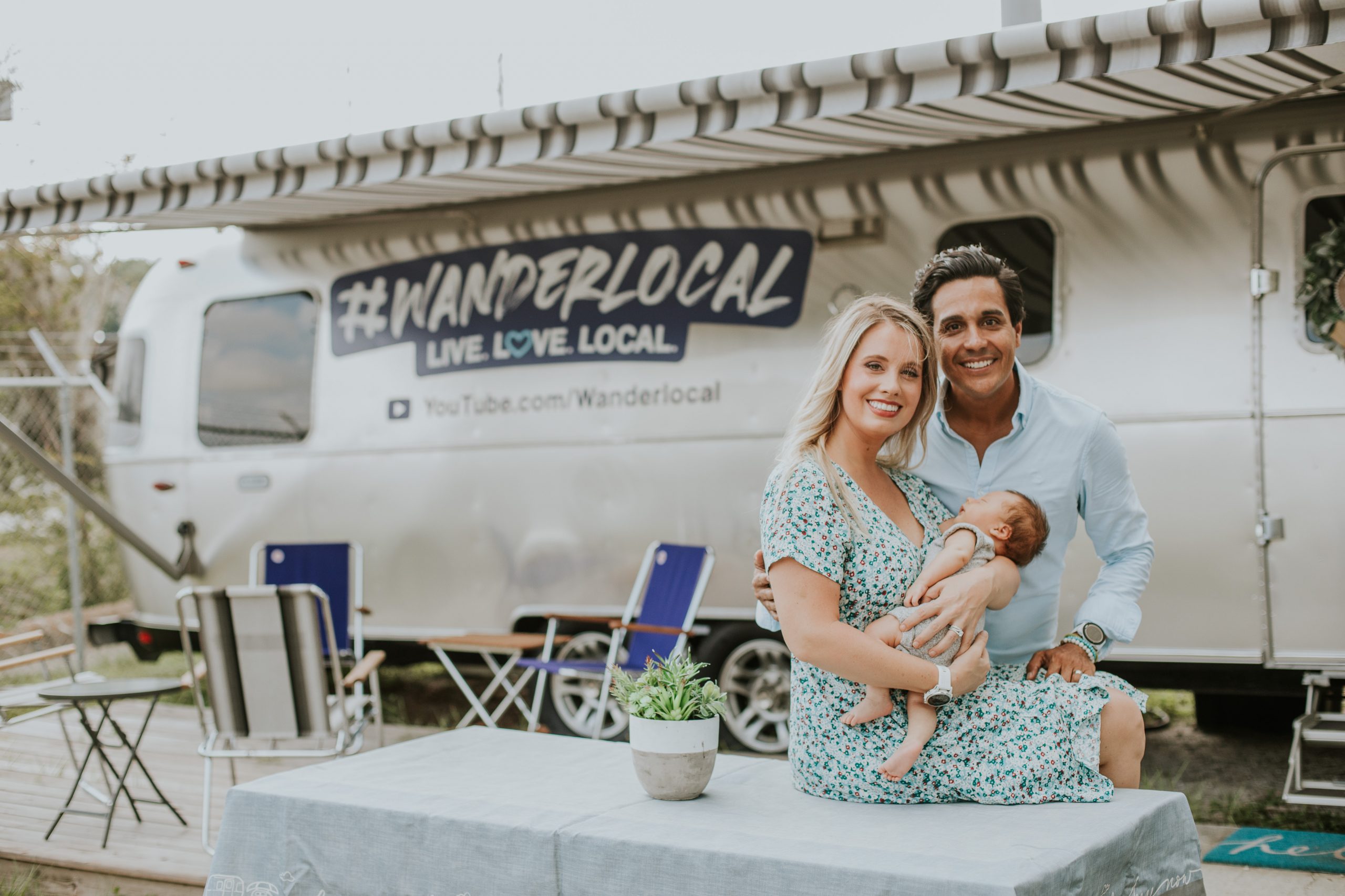 Lauren Davenport Fernandez and Daniel Fernandez with their baby beside the Wanderlocal Airstream
