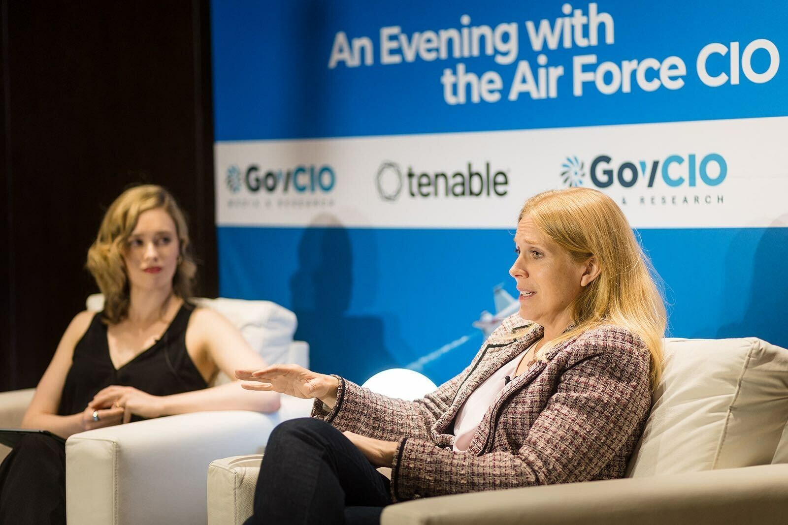 Lauren Knausenberger speaking from a white armchair during an Evening with the Air Force CIO event