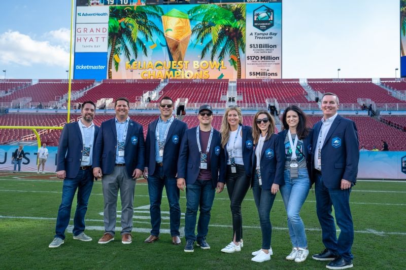 ReliaQuest teammates standing on the field after the 2023 ReliaQuest Bowl
