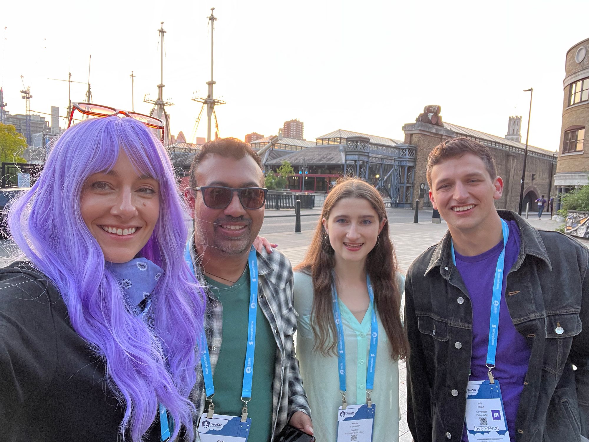 Four attendees at the London SaaStr gathering, one wearing a purple wig