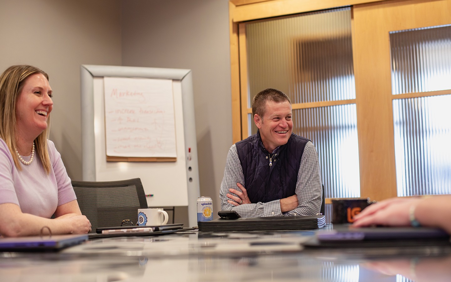 Lawrence and Schiller colleagues sharing a light moment around a conference table