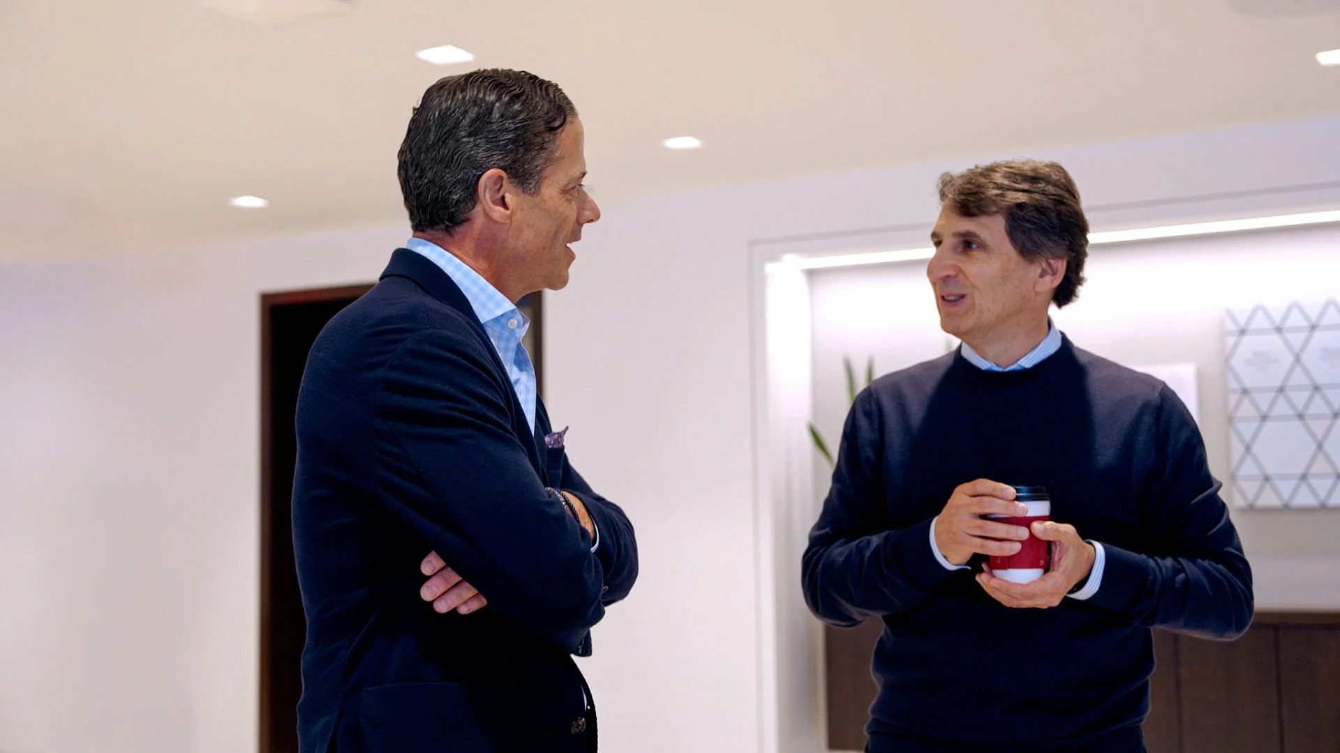 Lawrence Calcano speaking with Apollo chief executive Marc Rowan during a 2026 episode of The 19th Hole