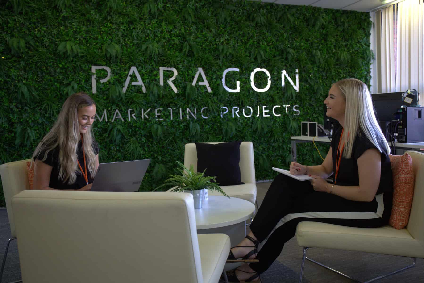 Two employees at Lead Forensics customer Paragon Marketing Projects working in an office