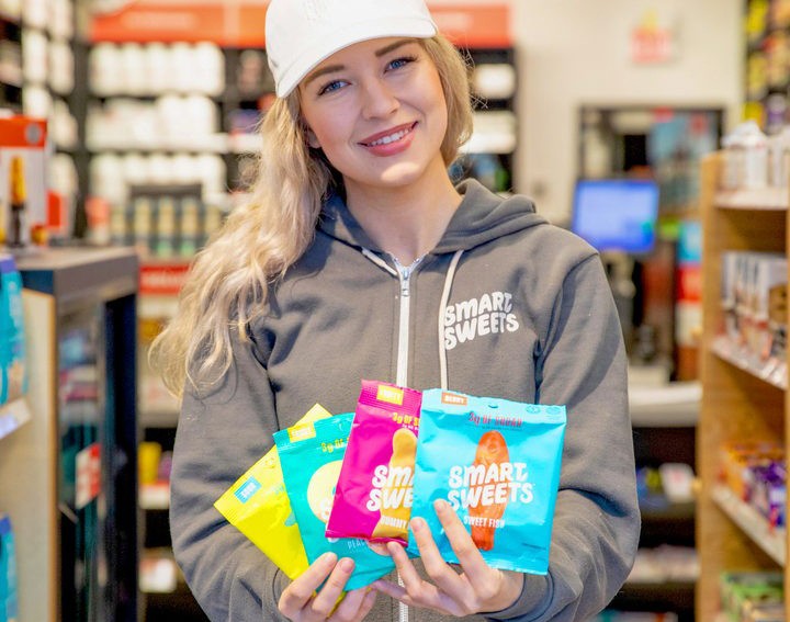 SmartSweets founder Tara Bosch holding packets of the company’s candy