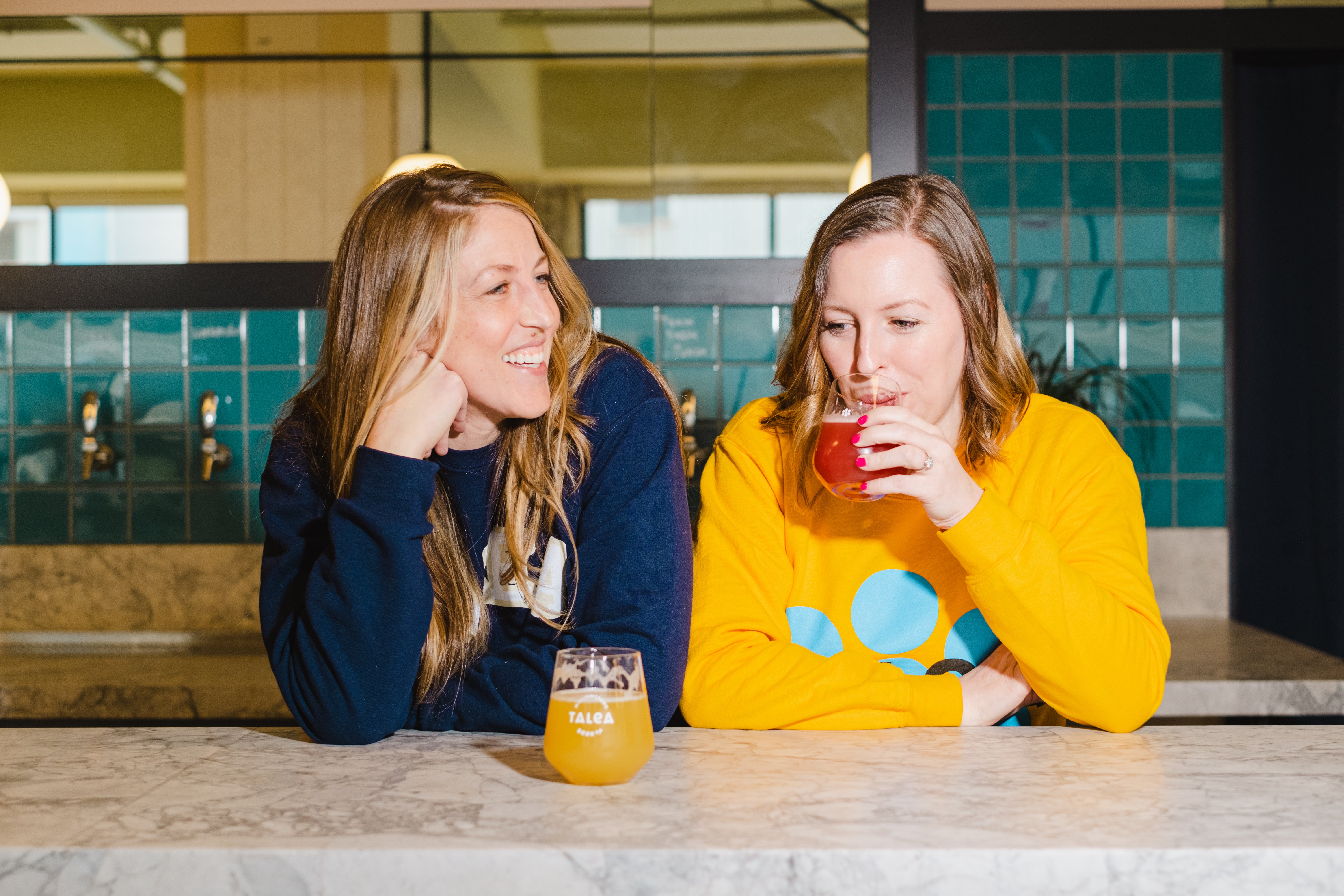 LeAnn Darland, left, and Tara Hankinson sharing a moment at a TALEA bar