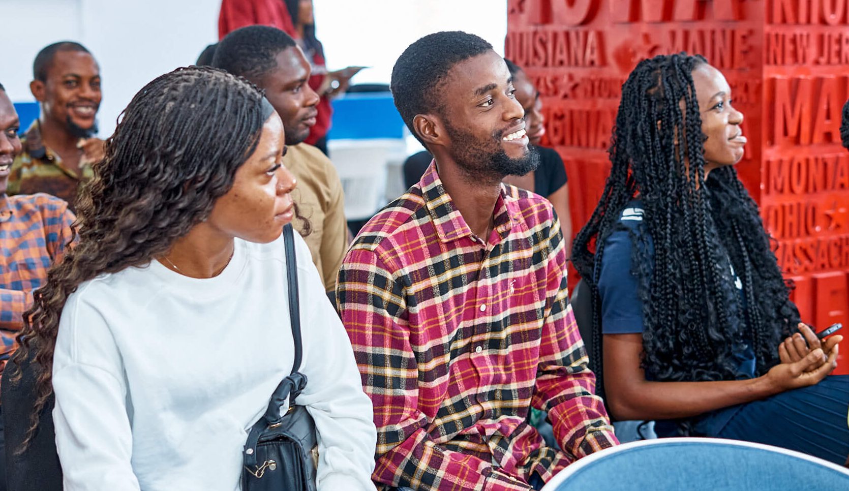 People seated together and listening at a gathering pictured on LeapSchool’s community page