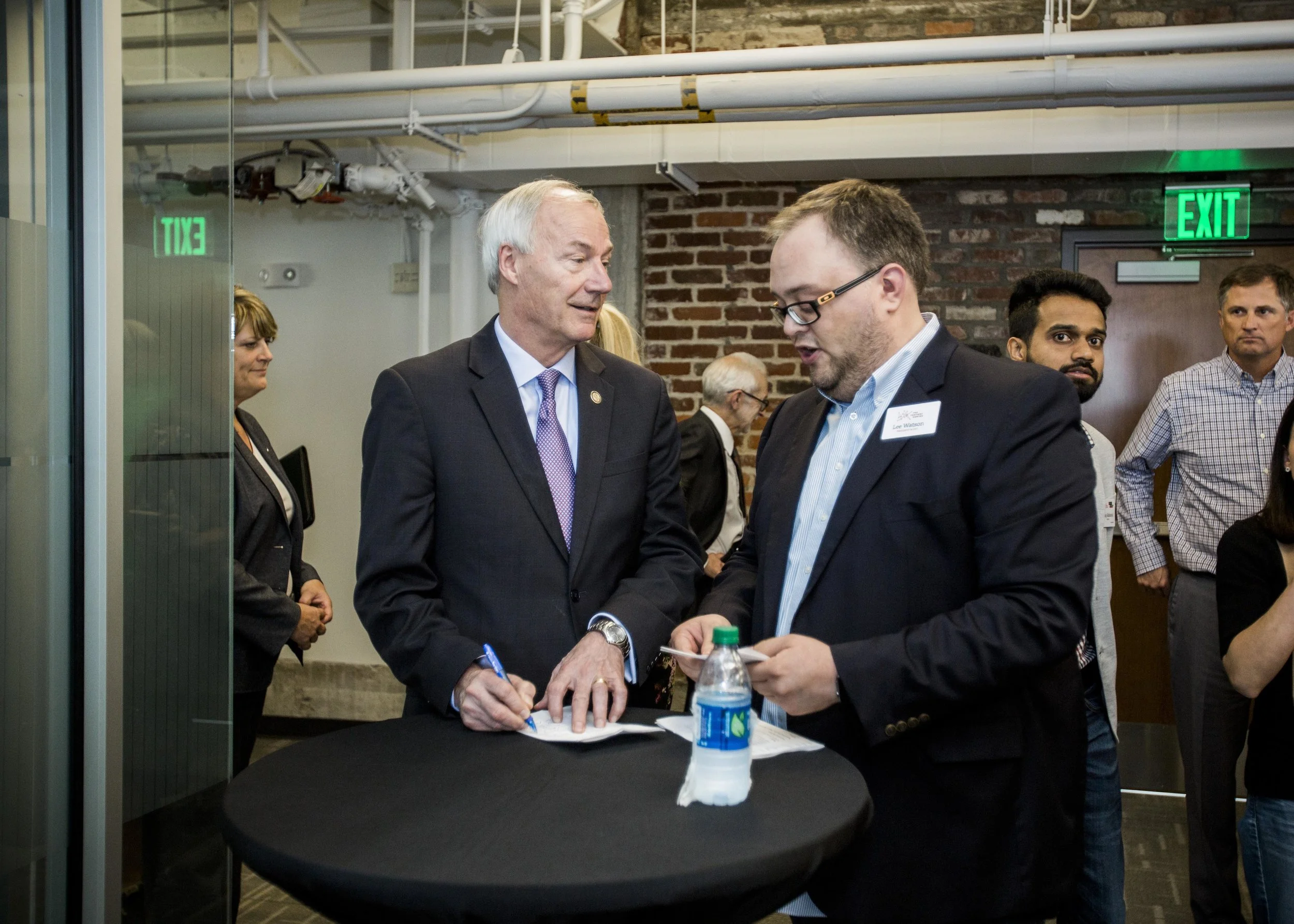 Lee Watson, at right, beside Asa Hutchinson during a Venture Center gathering