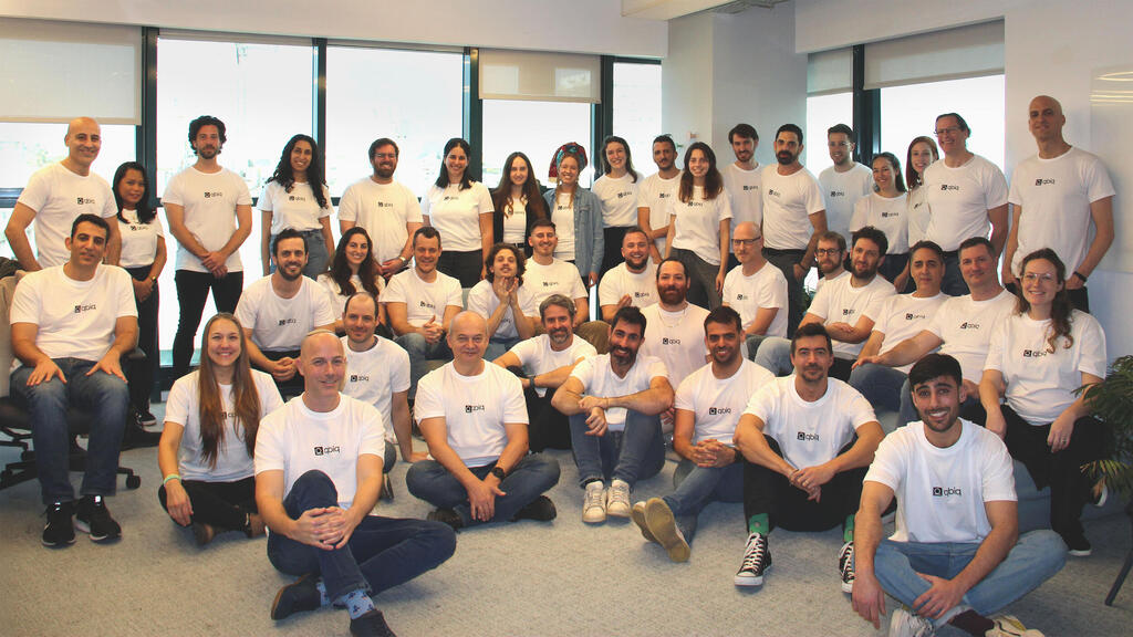 qbiq colleagues gathered for a company team photograph published in January 2025