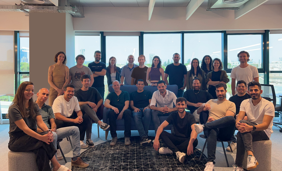 The qbiq team gathered in its office in a 2023 company photograph