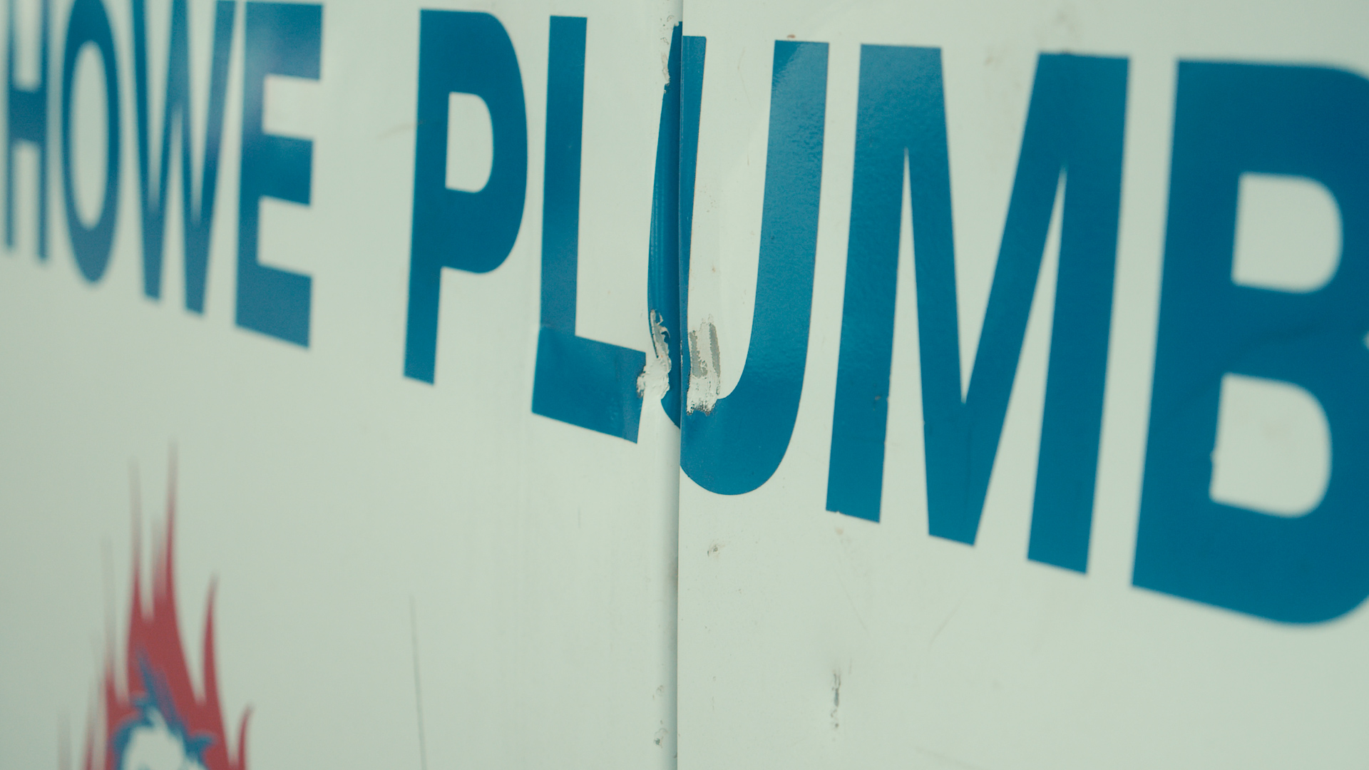 A plumbing service van door marked by an attempted break-in