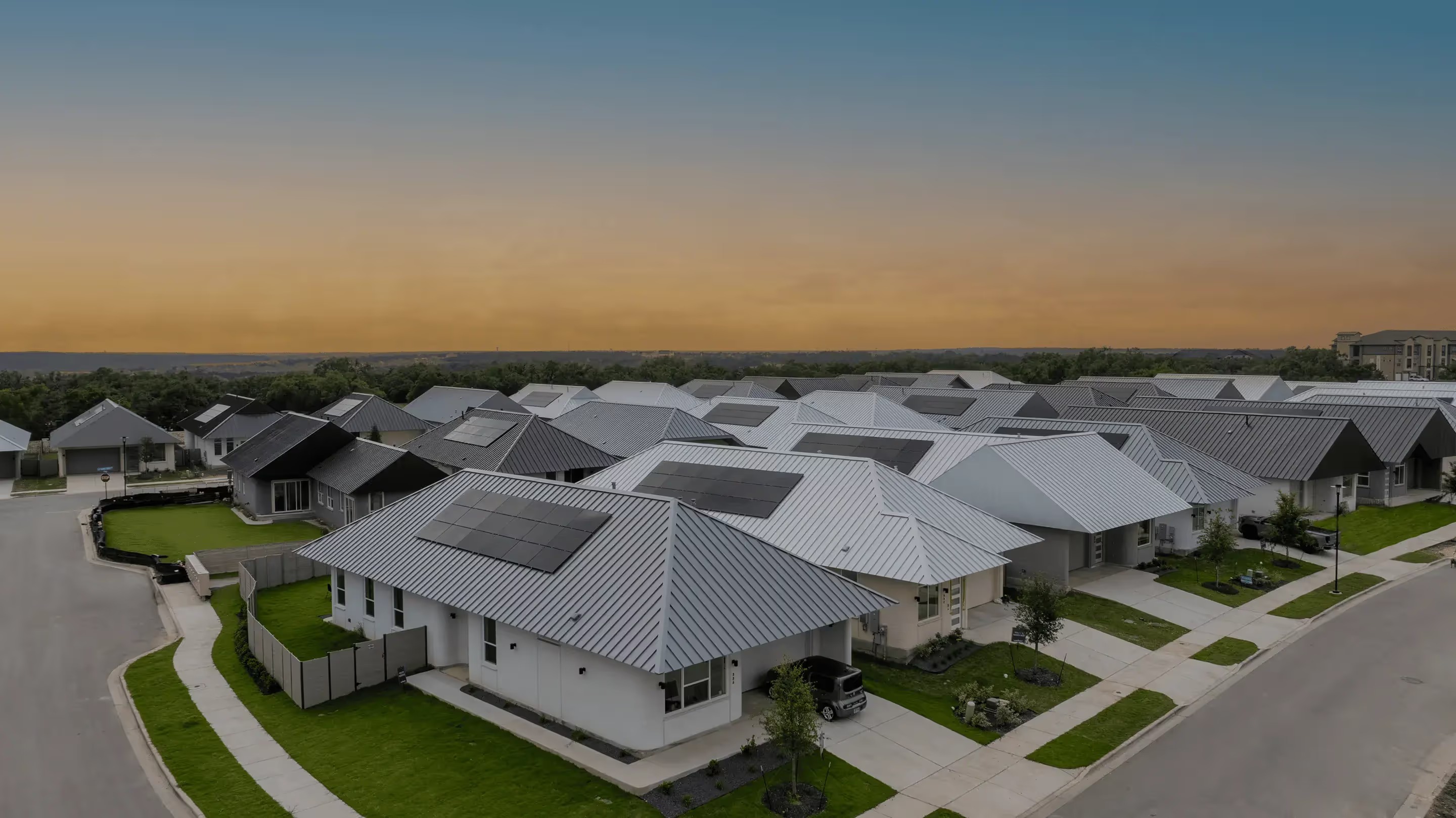 Aerial view of the Genesis Collection at Wolf Ranch, with solar panels on rows of single-story homes
