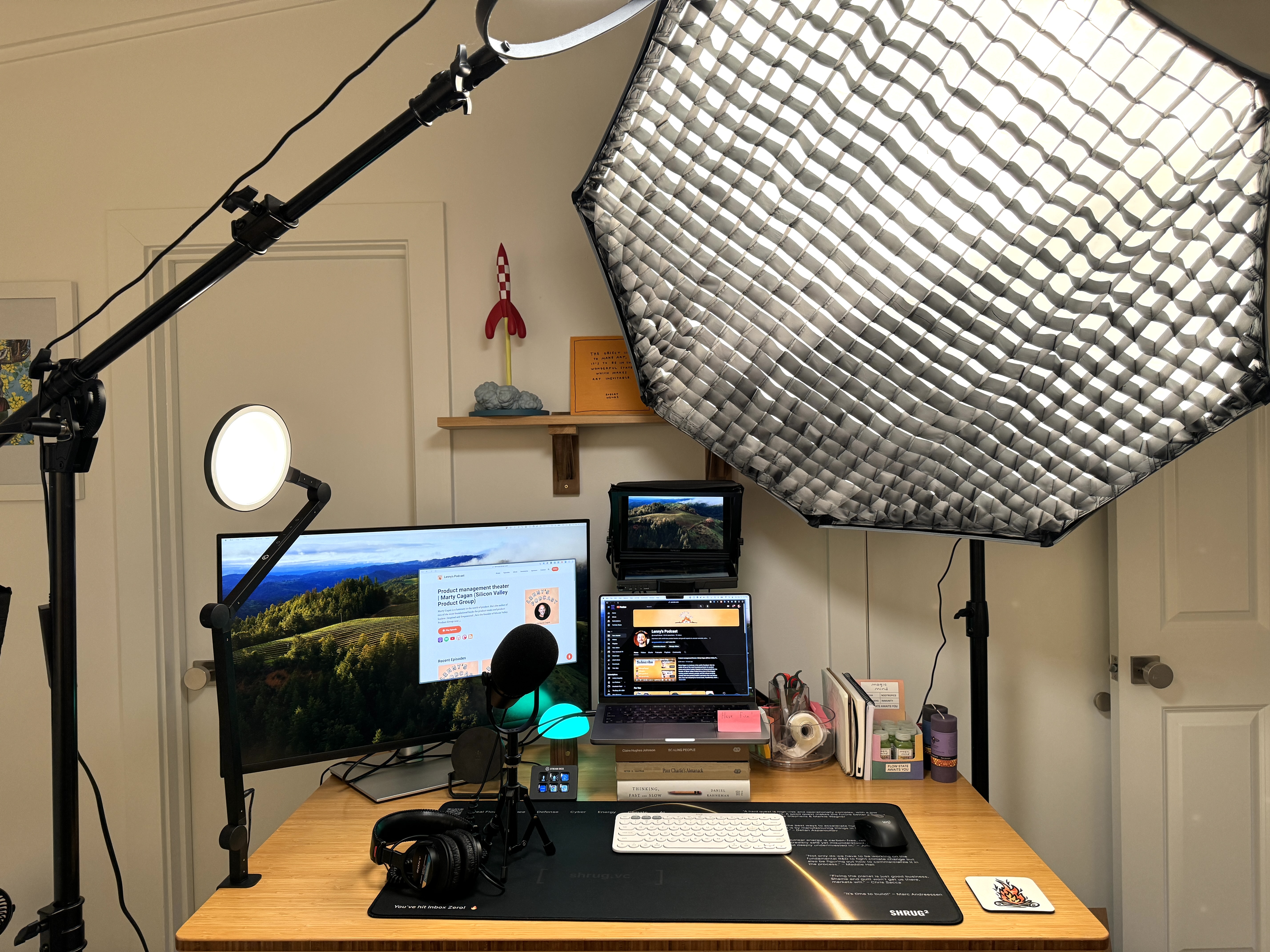 Lenny Rachitsky’s recording desk with microphone, monitors, camera and a large studio light