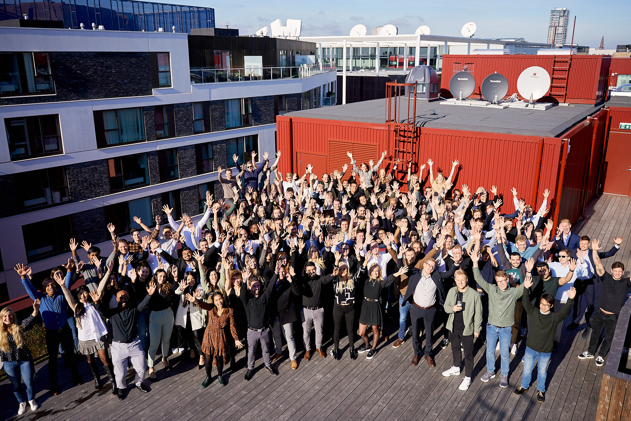 A large Lenus team gathering on a Copenhagen rooftop after the 2021 funding round