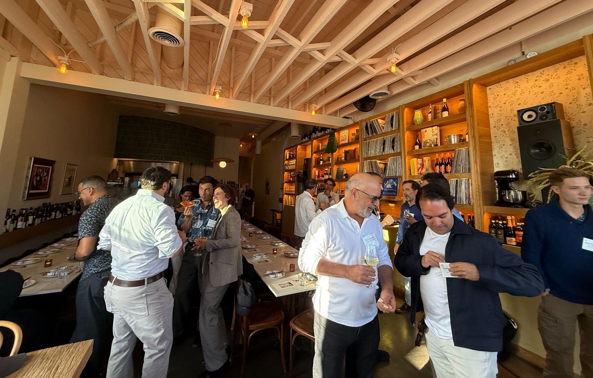 Leon Alkalai, in a white shirt near the center, talking with guests at Mandala's Los Angeles founders and investors dinner