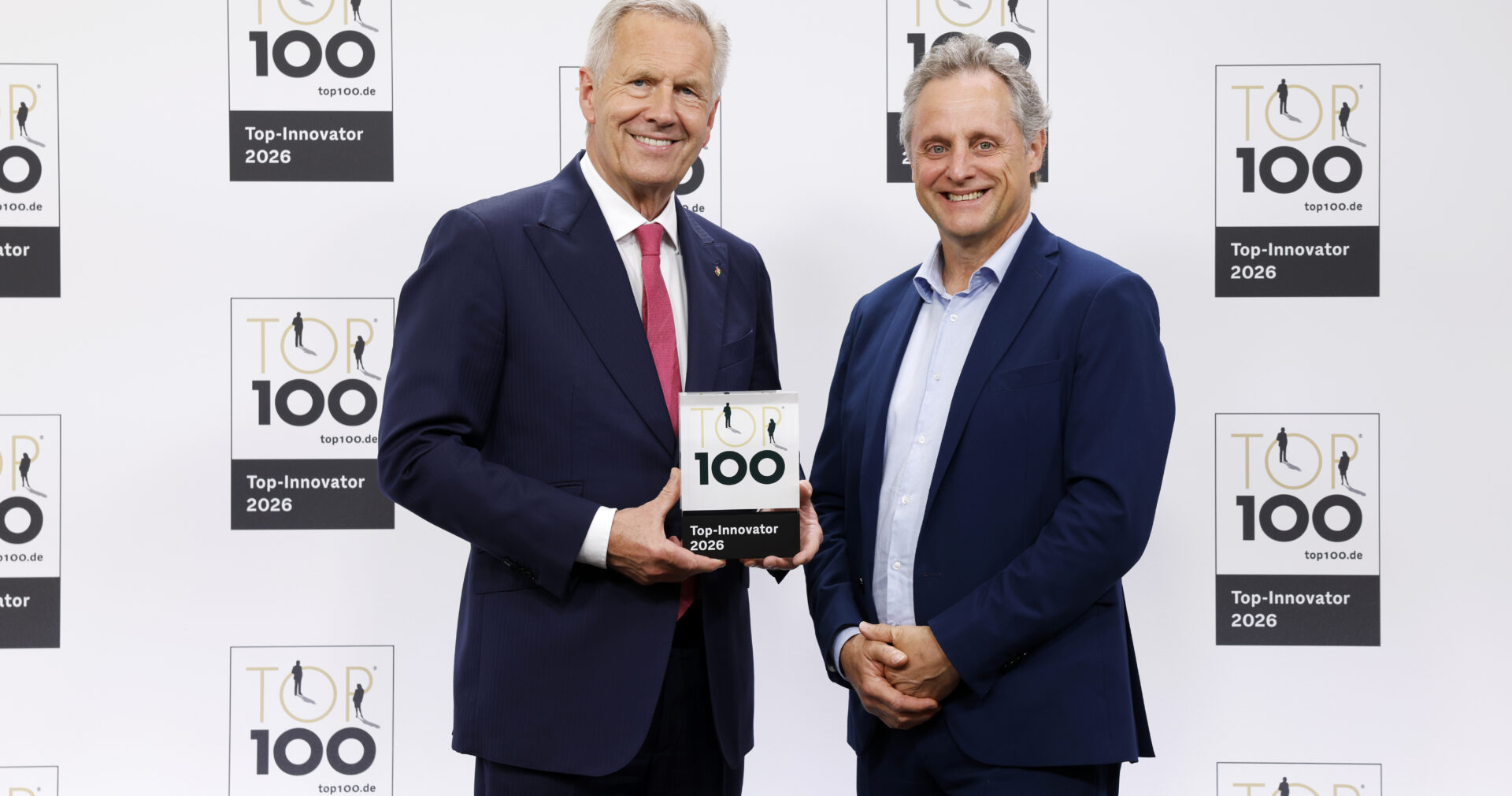 Leonardo Musso, right, holding KPS's 2026 TOP 100 award alongside the event presenter