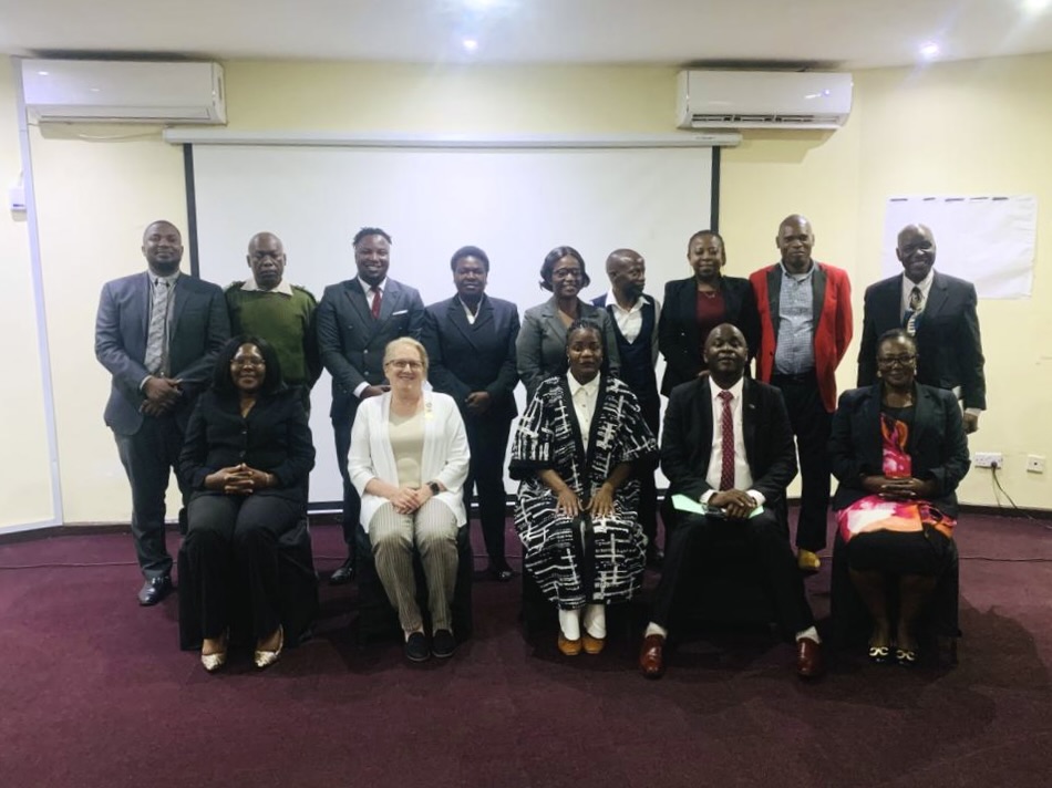 Leslie Durschinger, seated second from left, with government representatives and Kulera program partners in Malawi