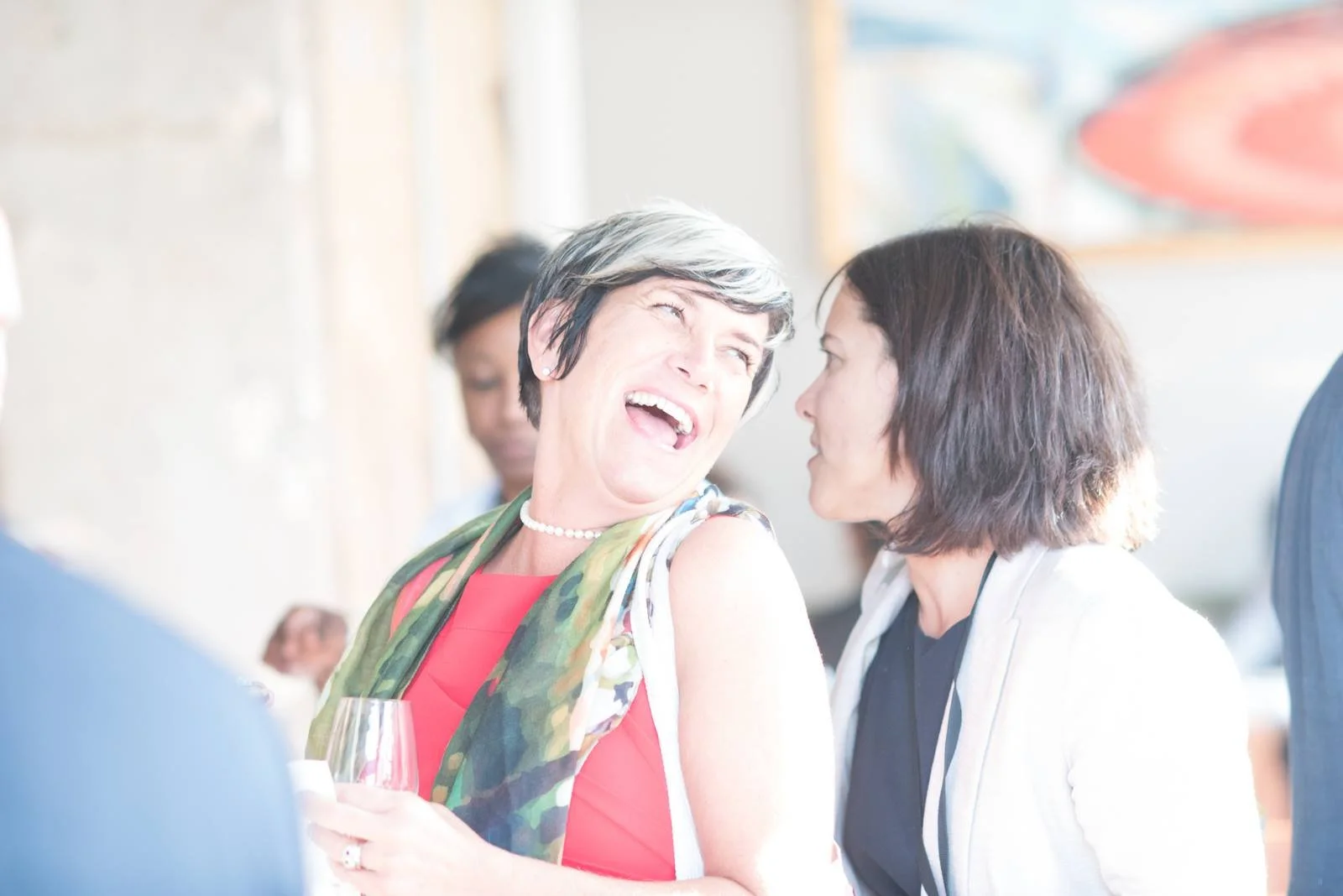 Leslie Lynn Smith laughing during a conversation at an entrepreneurship gathering
